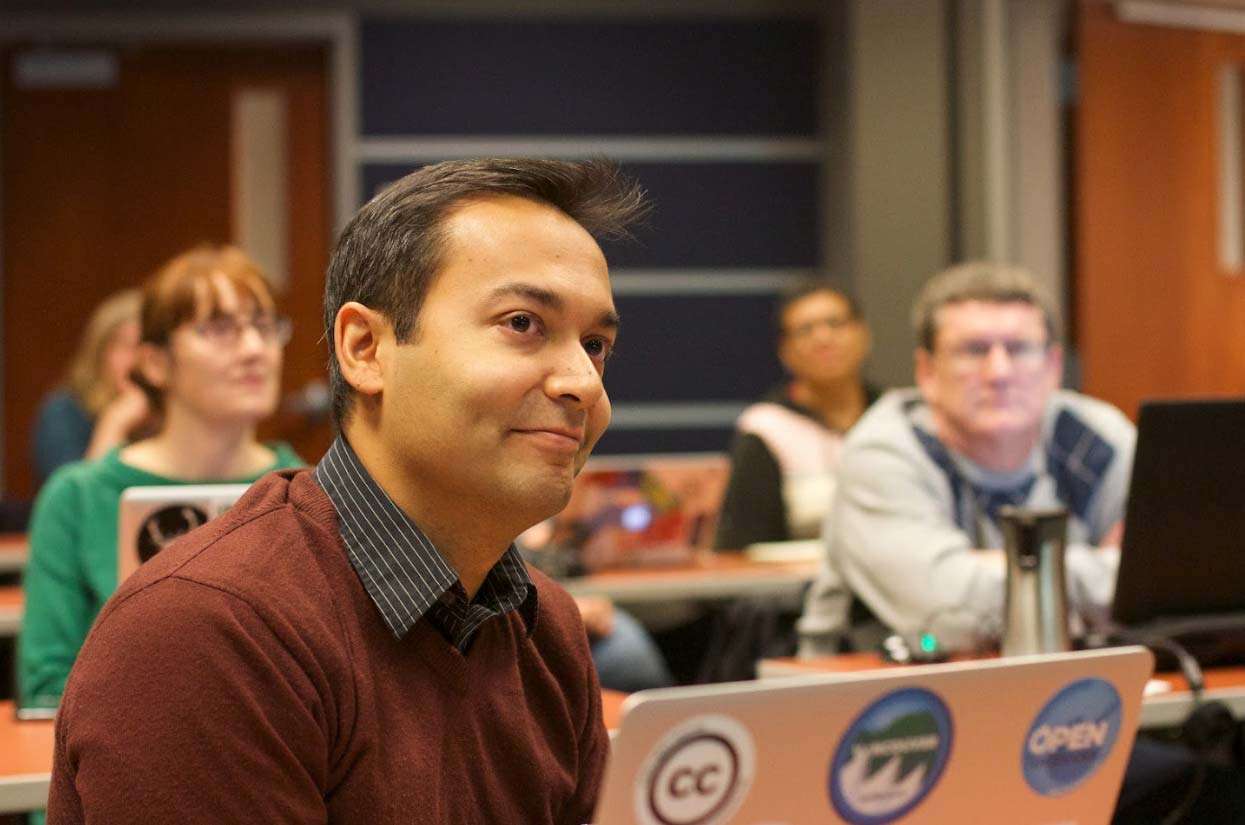 Engaged audience member in a classroom setting, focusing on learning and social brand building strategies.